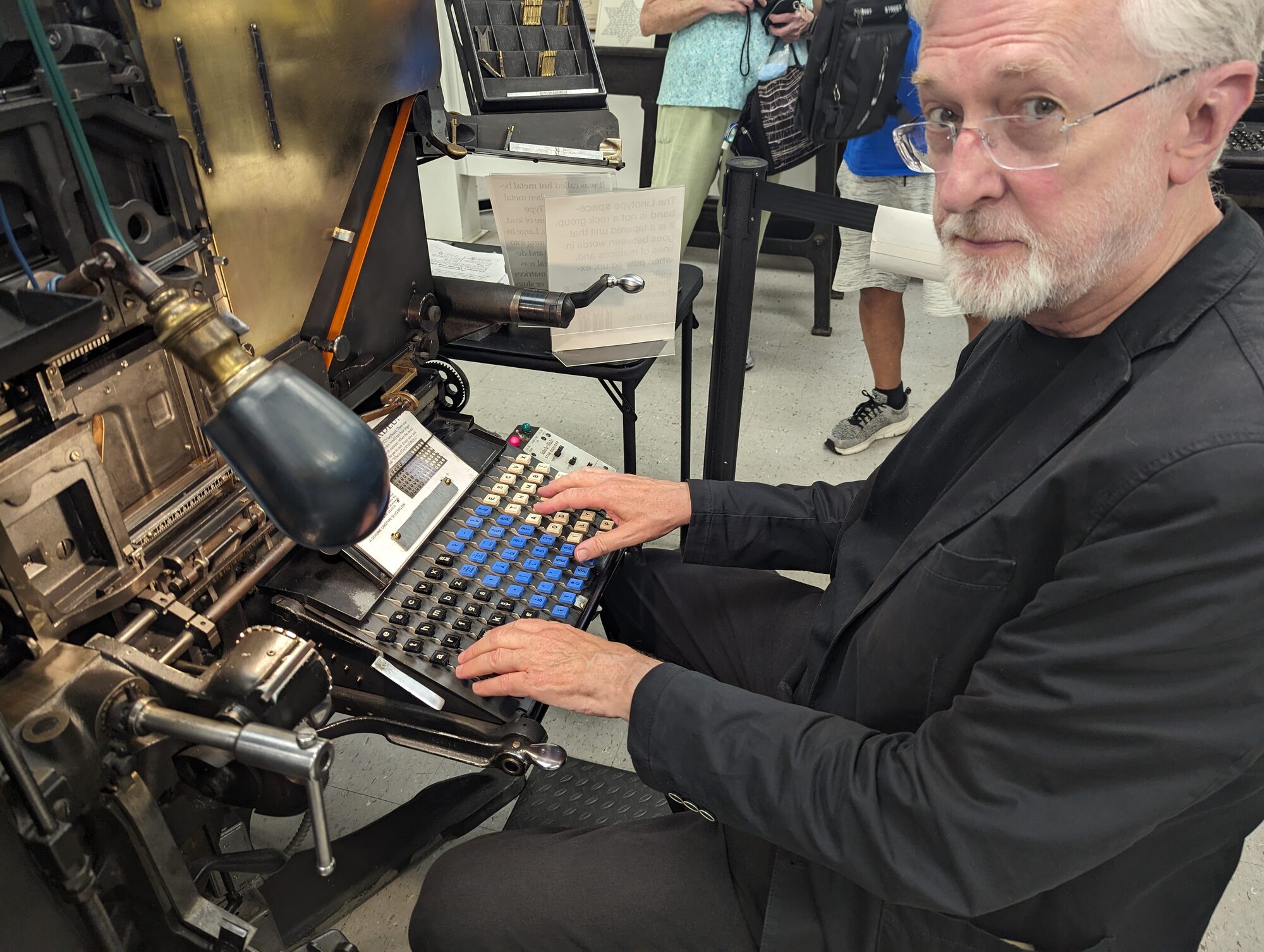 Jeff Jarvis standing beside a Linotype machine at the Museum of Printing